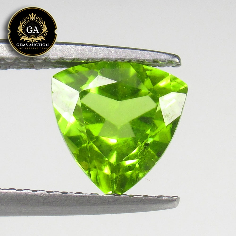 2.09 Ct Natural Parrot Green Peridot Trillion Cut: Weight - 2.09 Ct / Size - 8.00 x 8.00 x 5.00 mm / Shape - Trillion Cut / Color - Green / Clarity - VVS / Origin - Pakistan / Treatment - None