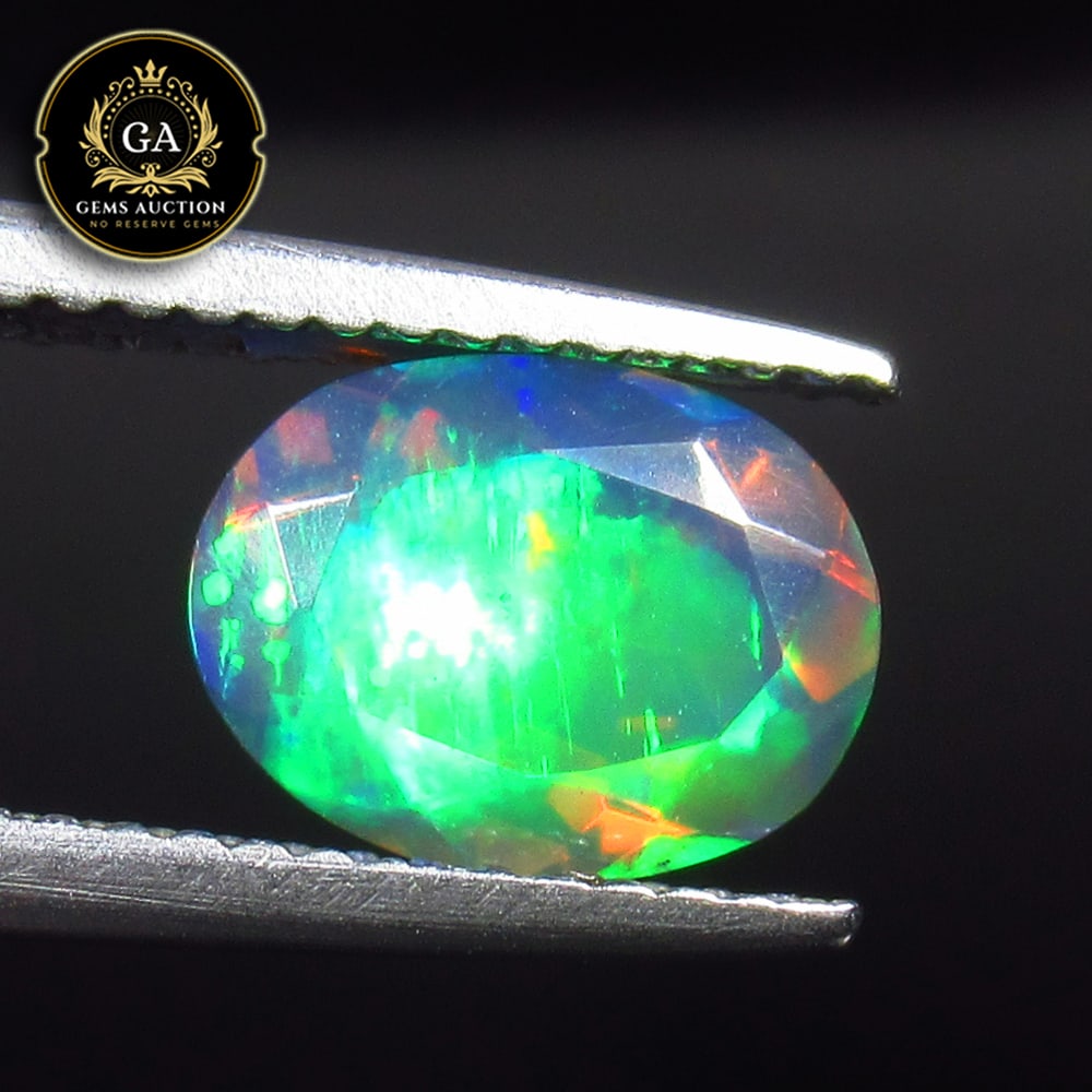 1.27 Ct Natural Black Faceted Fire Opal Oval Cut: Weight - 1.27 Ct / Size - 9.10 x 7.00 x 4.70 mm / Shape - Oval Cut / Color - Black / Clarity - Translucent / Origin - Ethiopia / Treatment - Heated