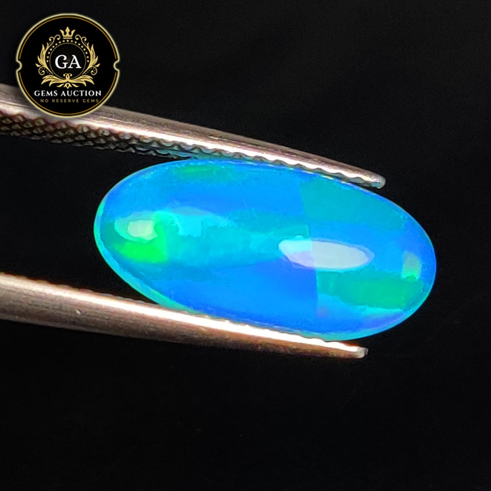 1.70 Ct Natural Blue Fire Opal Oval Cab: Weight - 1.70 Ct / Size - 14.00 x 7.30 x 3.40 mm / Shape - Oval Cab / Color - Blue / Clarity - Translucent / Origin - Ethiopia / Treatment - Heated