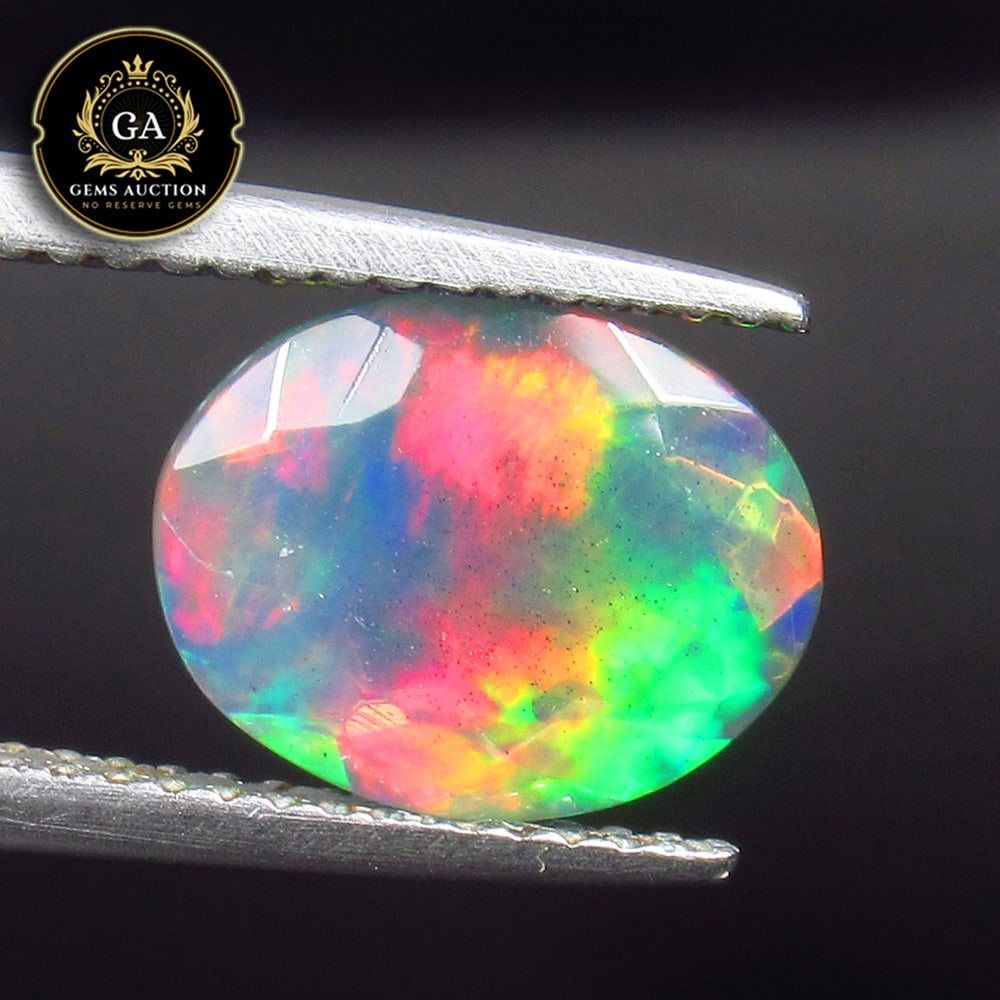 2.04 Ct Natural Black Faceted Fire Opal Oval Cut: Weight - 2.04 Ct / Size - 11.00 x 8.50 x 5.50 mm / Shape - Oval Cut / Color - Black / Clarity - Translucent / Origin - Ethiopia / Treatment - Heated