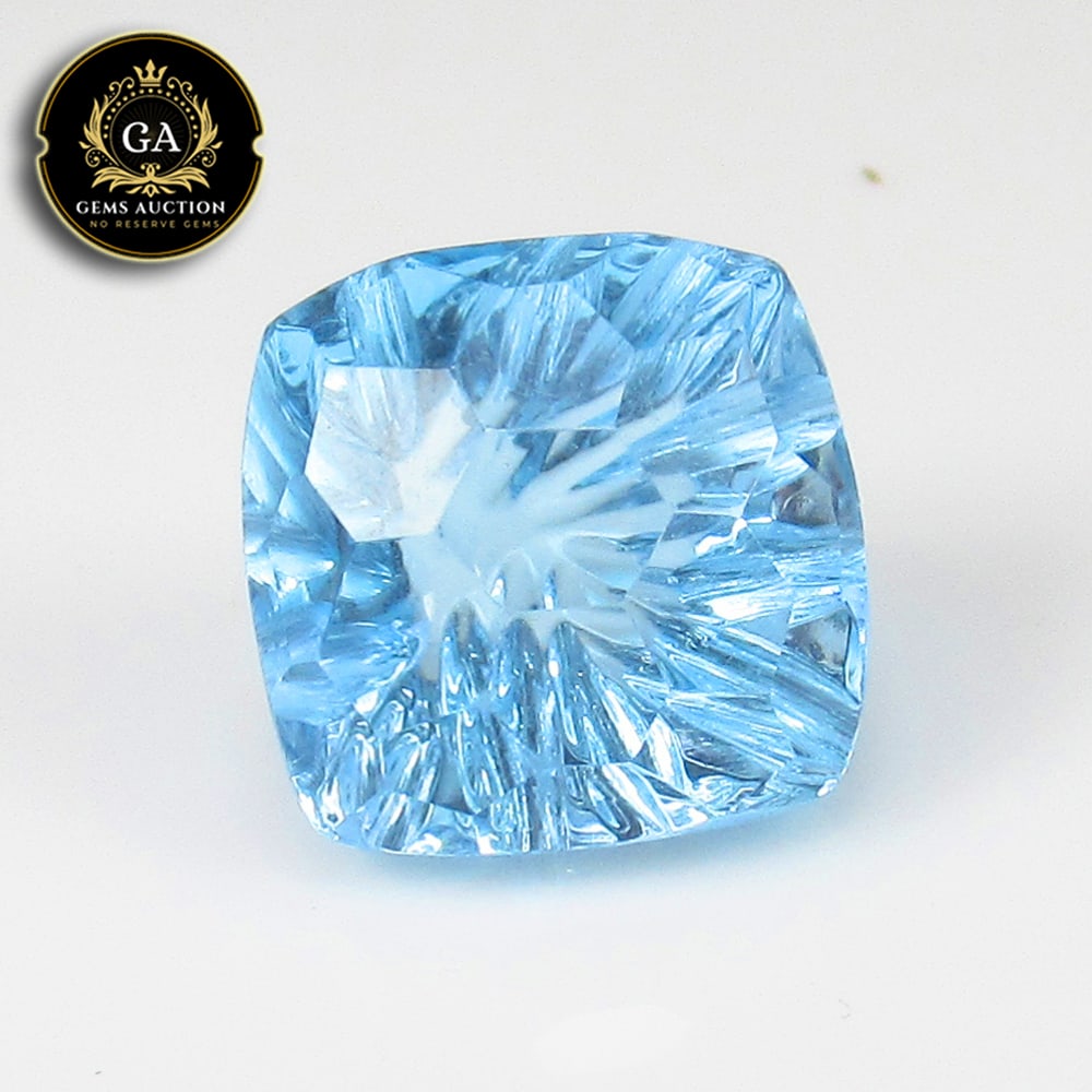 6.44 Ct Natural Blue Topaz Cushion Football Cut: Weight - 6.44 Ct / Size - 10.00 x 10.00 x 7.40 mm / Shape - Cushion Football Cut / Color - Blue / Clarity - VVS / Origin - Brazil / Treatment - Irradiated
