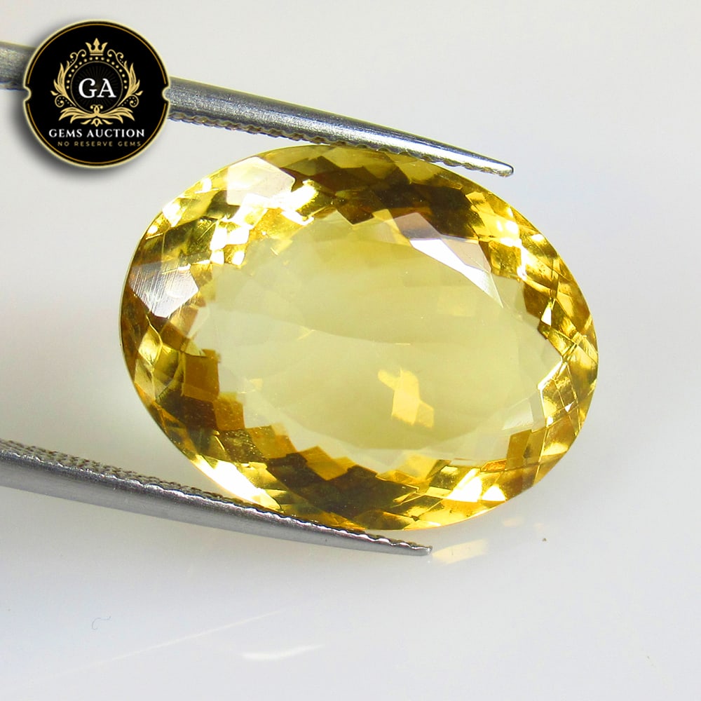 16.61 Ct Natural Citrine Oval Cut: Weight - 16.61 Ct / Size - 19.50 x 15.10 x 9.10 mm / Shape - Oval Faceted Cut / Color - Yellow / Clarity - VVS / Origin - Brazil / Treatment - None