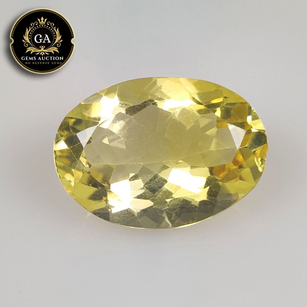 12.69 Ct Natural Yellow Citrine Oval Cut: Weight - 12.69 Ct / Size - 19.70 x 14.00 x 8.30 / Shape - Oval Faceted Cut / Color - Yellow / Clarity - VVS / Origin - Brazil / Treatment - Heated