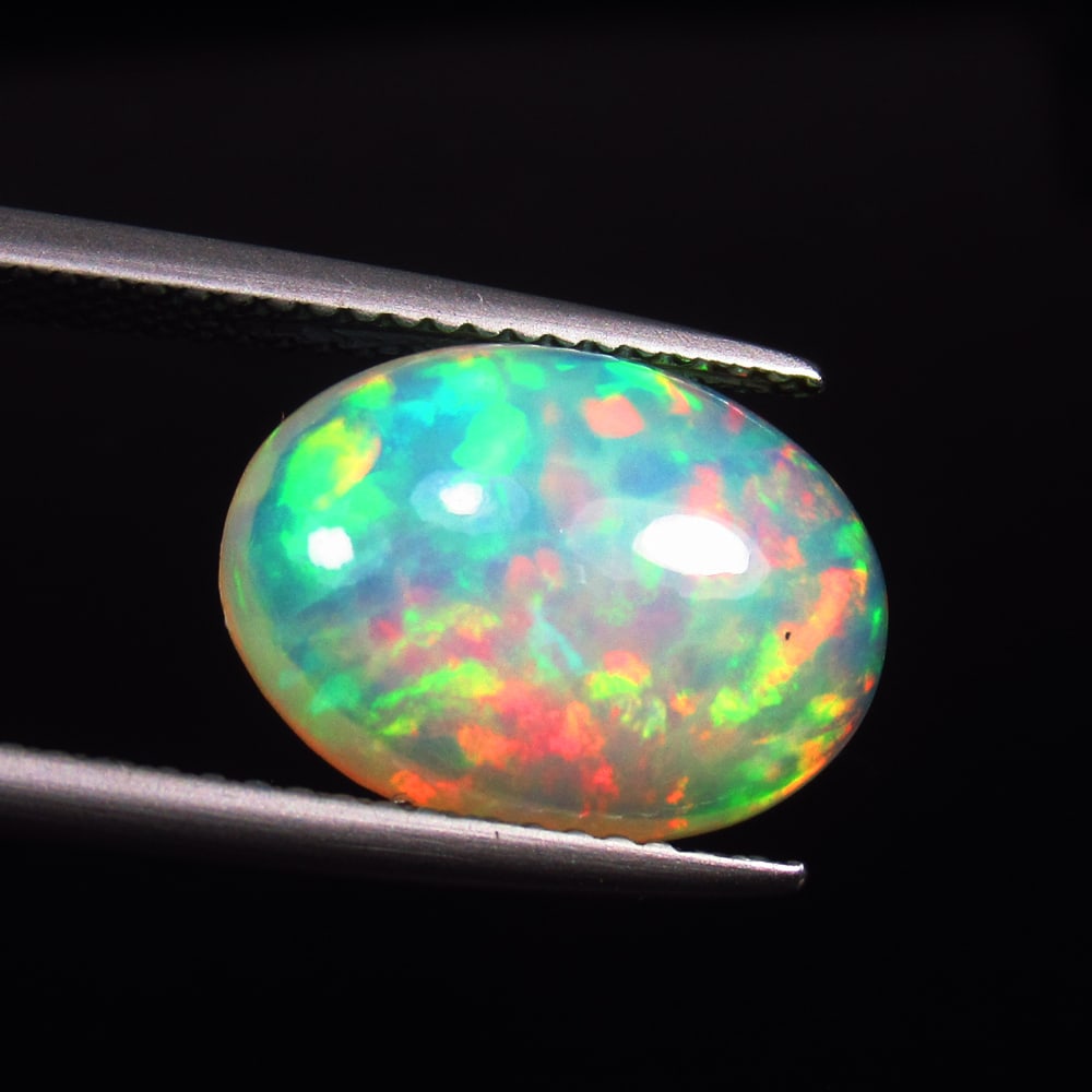4.15 Ct GIT CERTIFIED Natural Milticolor Welo Opal Oval Cab: Weight - 4.15 Ct / Dimensions - 14.10 x 10.03 x 6.05 mm / Shape & Cut - Oval Cab / Color - Multicolor Fire / Transparency - Transparent / Origin - Ethiopia / Comments - None