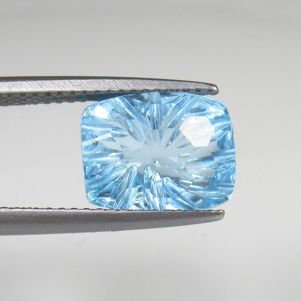 5.25 Ct Natural Blue Topaz Cushion Carving Cut: Weight - 5.25 Ct / Dimensions - 11.00 x 8.80 x 6.00 mm / Shape & Cut - Cushion Carving / Color - Blue / Transparency - VVS / Origin - Brazil / Comments - Irradiated