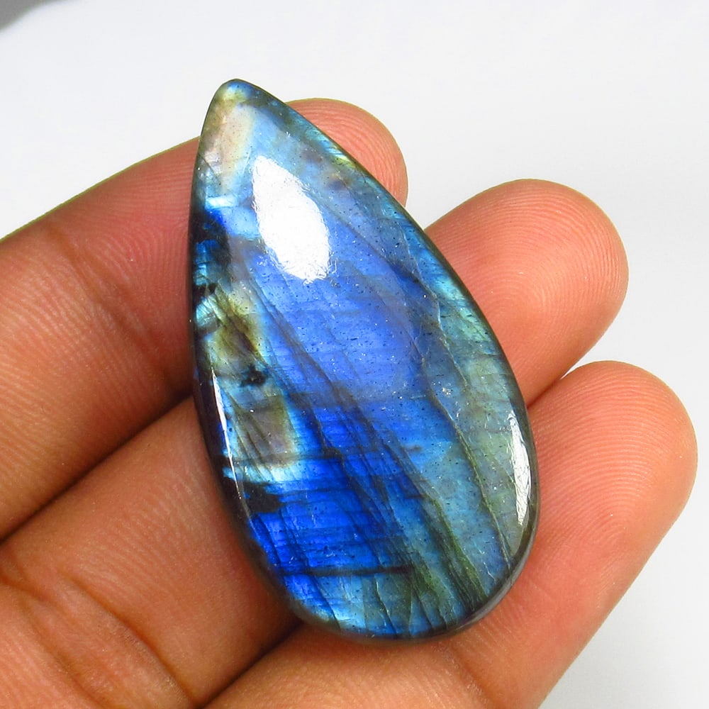 69.00 Ct Natural Blue Shaded Labradorite Pear Cab: Weight - 69.00 Ct / Dimensions - 43.00 x 22.00 x 8.00 mm / Shape & Cut - Excellent Pear Cabochon / Transparency - Opaque / Origin - Africa / Comments - None