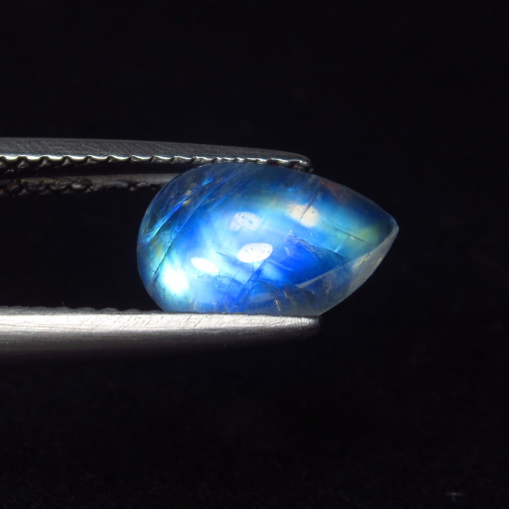 1.81 Ct Natural Blue Tint Moonstone Pear Cab: Weight - 1.81 Ct / Size - 10.00 x 7.00 x 3.50 mm / Shape - Pear Cab / Clarity - Semi-Transparent / Origin - India / Treatment - None