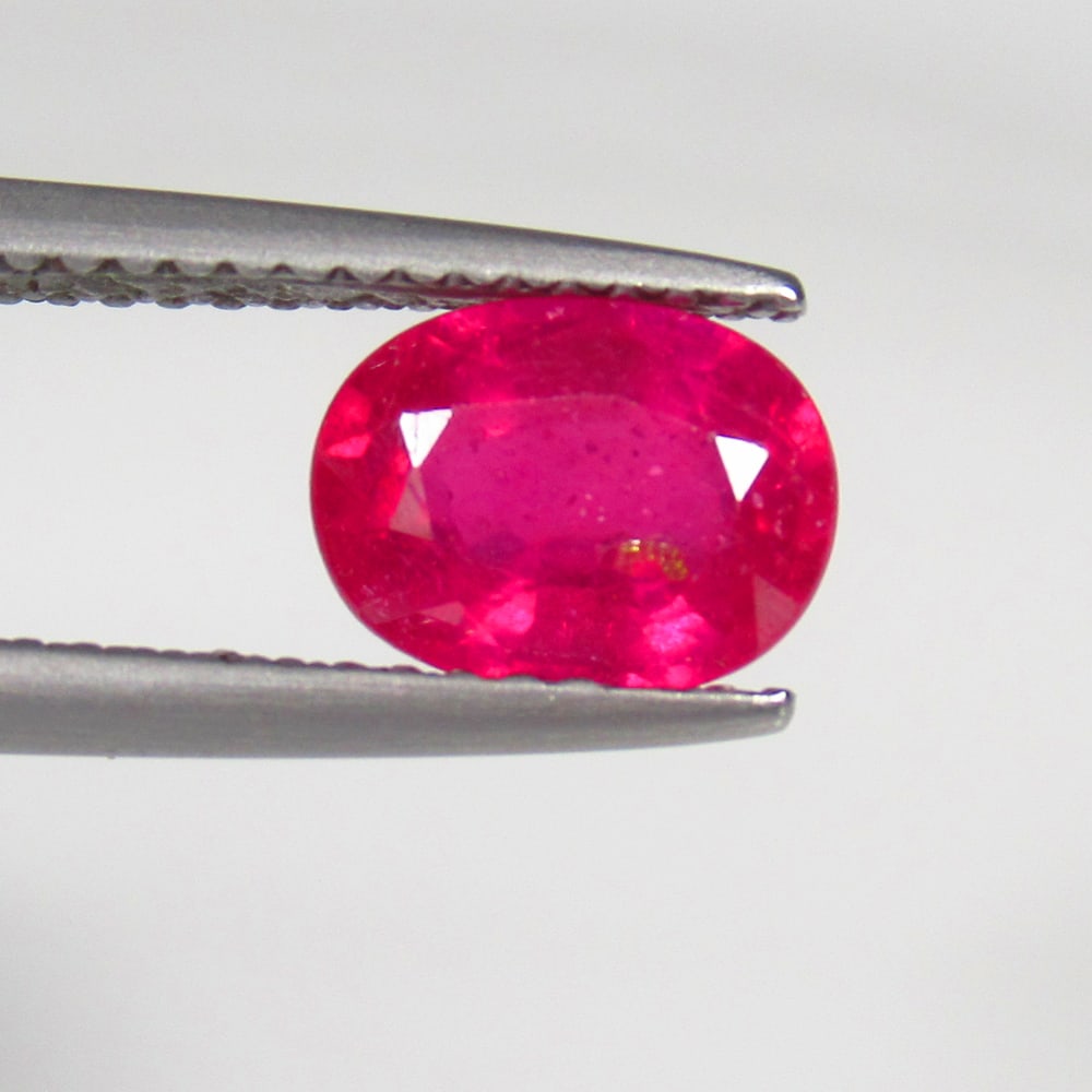 1.63 Ct Natural Pinkish Red Ruby Oval Cut: Weight - 1.63 Ct / Size - 8.00 x 6.10 x 3.70 mm / Shape - Oval Cut / Color - Red / Clarity - SI / Origin - Mozambique / Treatment - Color Enhanced by Glass Filling