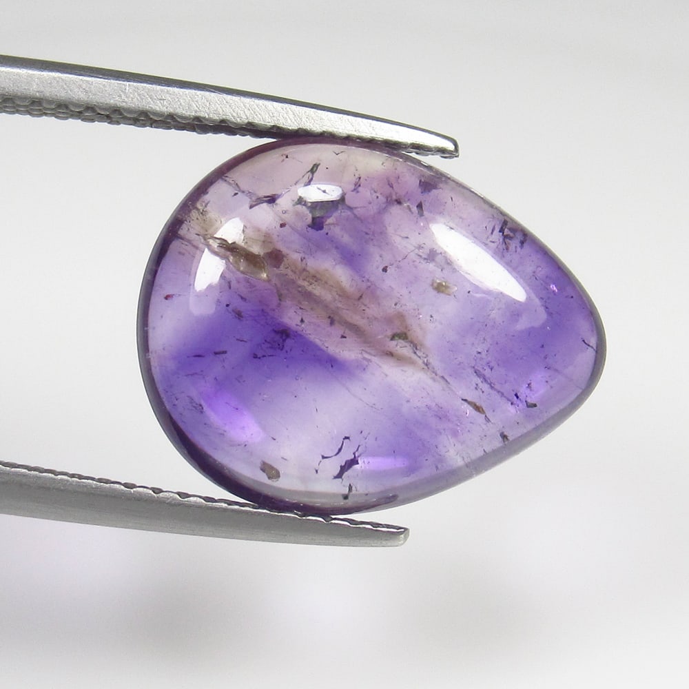 6.82 Ct Natural Rutile Amethyst Quartz Pear Cab: Weight - 6.82 Ct / Size - 15.50 x 12.40 x 5.00 mm / Shape - Pear Cab / Color - Purple / Clarity - Transparent / Origin - Norway / Treatment - None