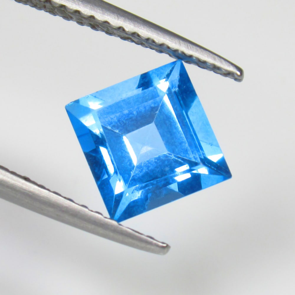 2.00 Ct Natural Blue Topaz Square Cut: Weight - 2.00 Ct / Size - 7.00 x 7.00 x 4.80 mm / Shape - Square Cut / Color - Blue / Clarity - VVS / Origin - Brazil / Treatment - Irradiated