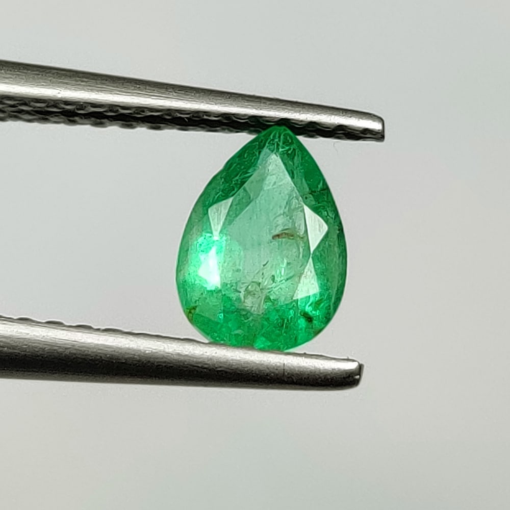 0.60 Ct Natural Zambian Green Emerald Pear Cut: Weight - 0.60 Ct / Size - 7.00 x 5.00 x 3.10 mm / Shape - Pear Cut / Color - Green / Clarity - SI / Origin - Zambia / Treatment - Natural Emeralds are commonly enhanced by oil