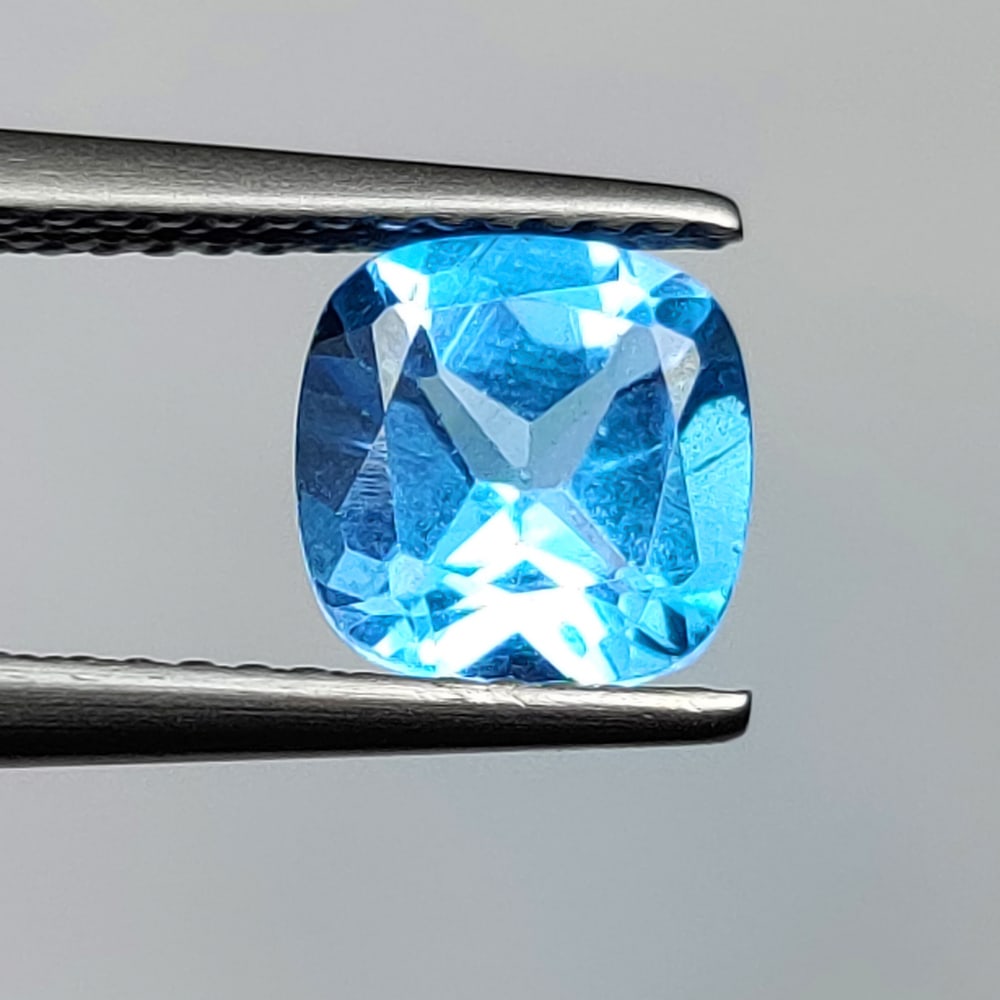 1.84 Ct Natural Blue Topaz Cushion Cut: Weight - 1.84 Ct / Size - 7.20 x 7.20 x 4.60 mm / Shape - Cushion Cut / Color - Blue / Clarity - VVS / Origin - Brazil / Treatment - Irradiated