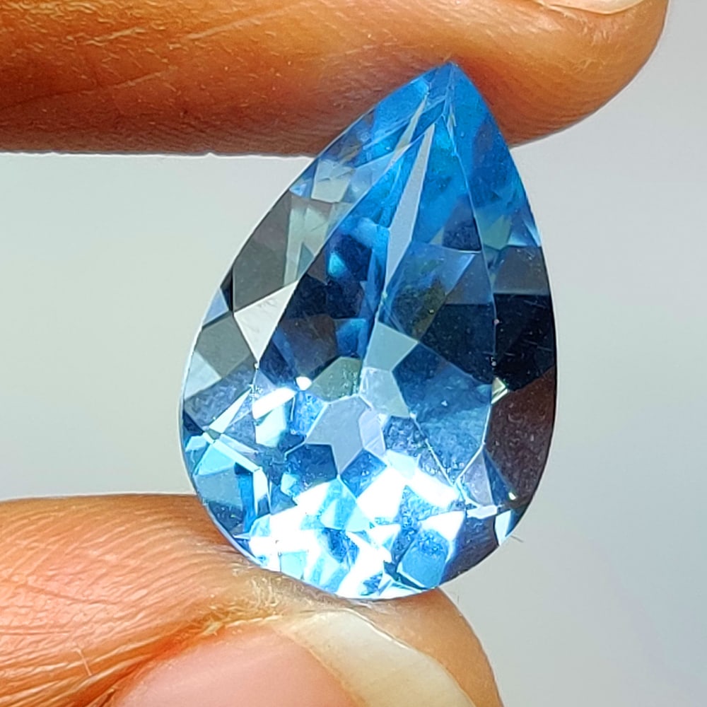 6.61 Ct Natural Blue Topaz Pear Cut: Weight - 6.61 Ct / Size - 14.90 x 10.20 x 6.80 mm / Shape - Pear Cut / Color - Blue / Clarity - VVS / Origin - Brazil / Treatment - Irradiated