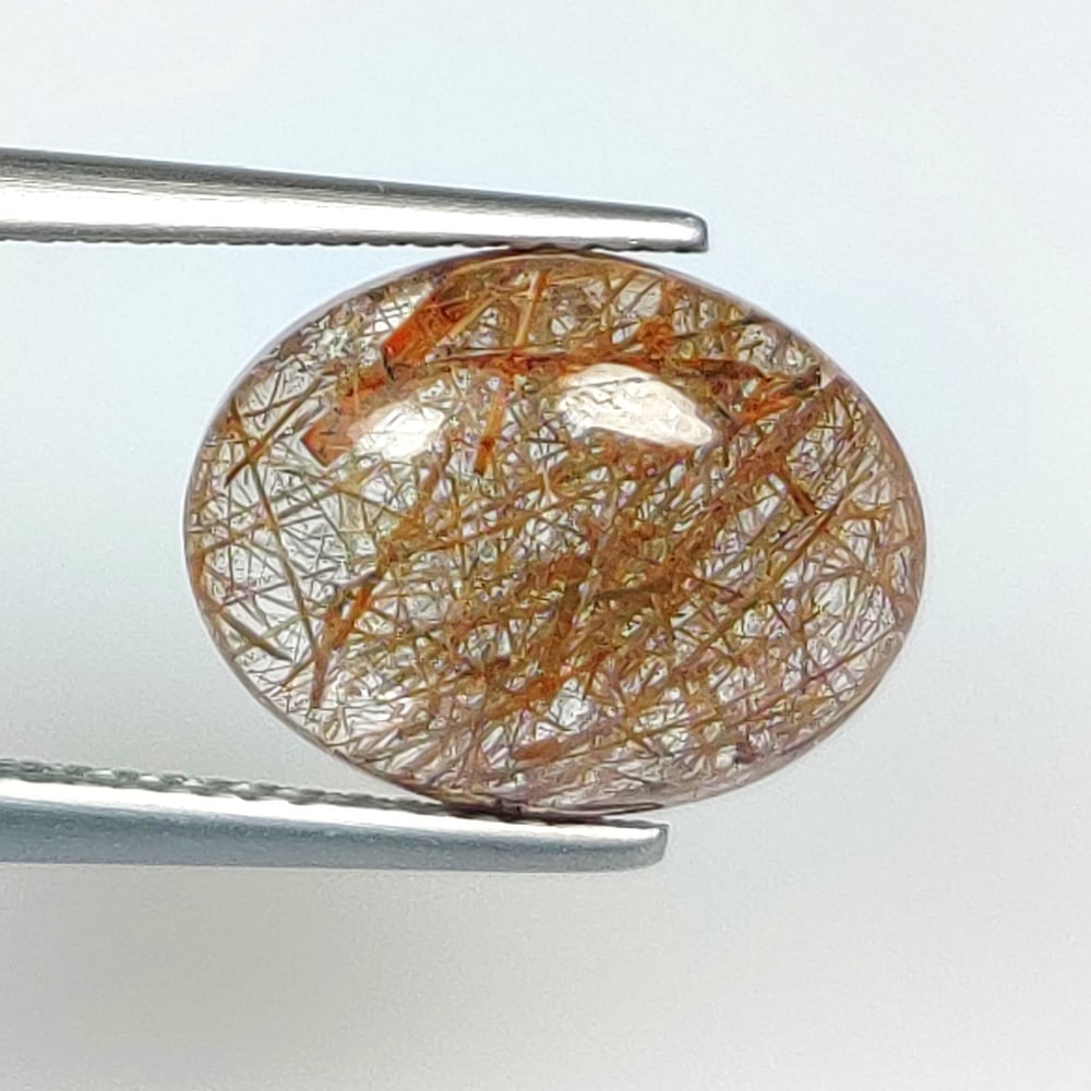 6.10 Ct Natural Brown Hair Rutile Quartz Oval Cab: Weight - 6.10 Ct / Dimensions - 13.30 x 10.30 x 6.00 mm / Shape & Cut - Oval cab / Transparency - Transaprent / Origin - Norway / Comments - None