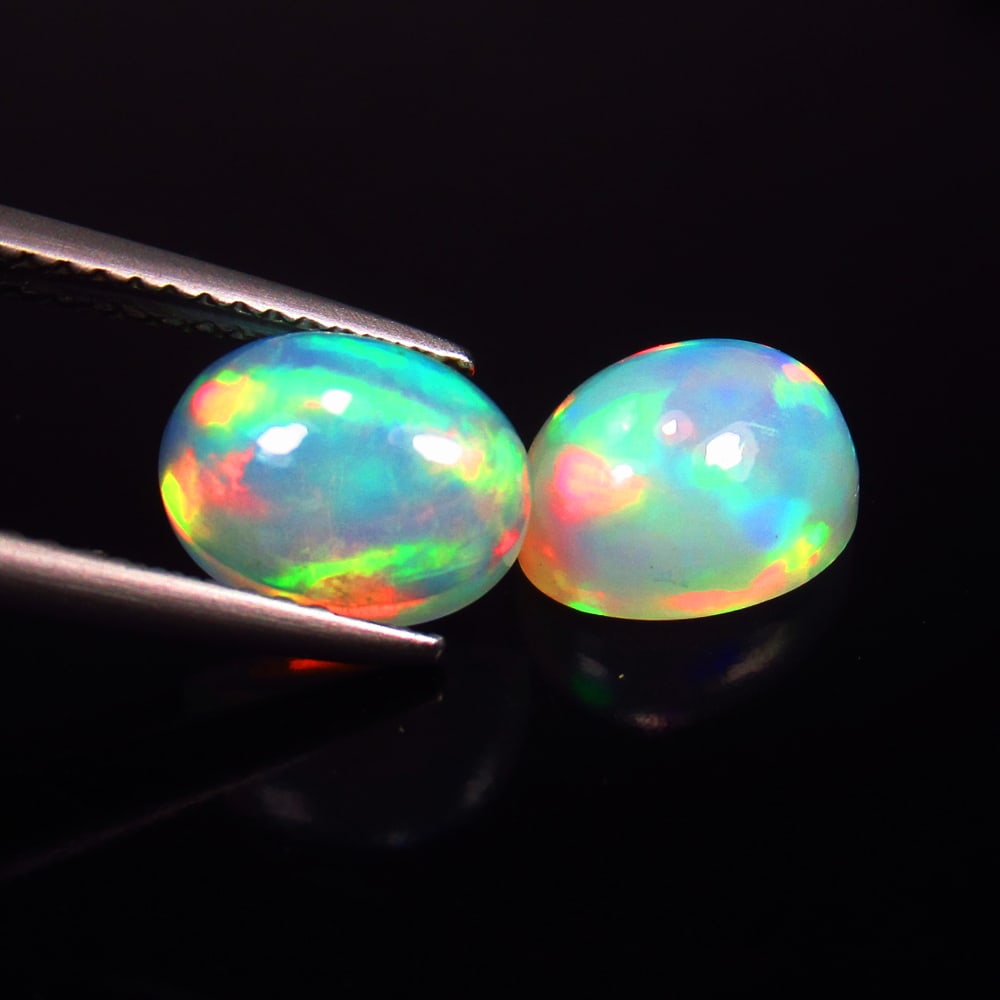 3.37 Ct Natural Multicolor Welo Opal Top Fire Oval Cab Pair: Weight - 3.37 Ct / Size - 9.30 x 7.30 x 5.40 mm / 2 Pc's / Shape - Oval Cab / Color - Multicolor / Clarity - Translucent / Origin - Ethiopia / Treatment - None
