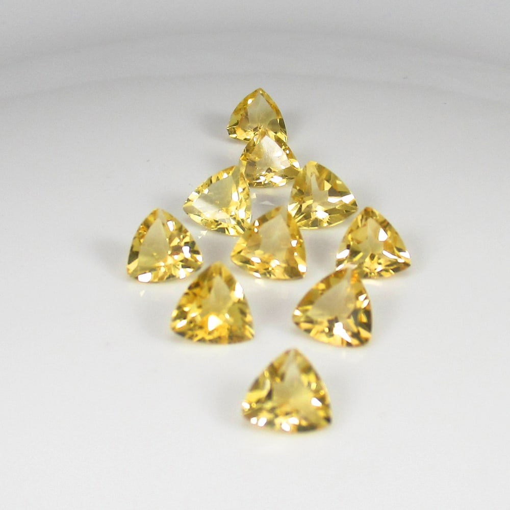 6.47 Ct Natural Yellow Citrine Trillion Cut Set: Weight - 6.47 Ct / Size - 6.0x6.0 - 6.2x6.2 mm / 10 Pc's / Shape - Trillion Cut / Color - Yellow / Clarity - VVS / Origin - Brazil / Treatment - Heated