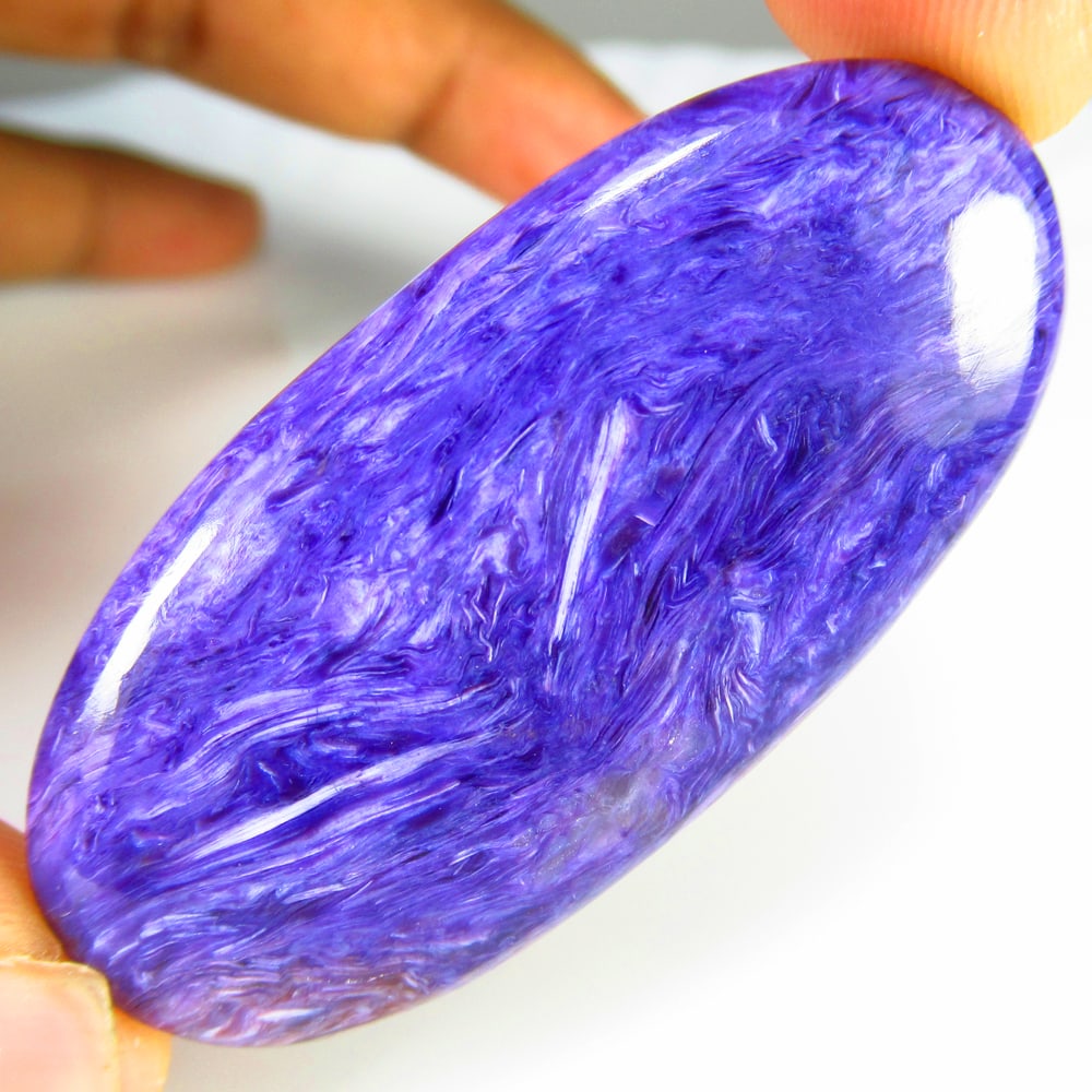 74.19 Ct Natural Purple Charoite Oval Cab: Weight - 74.19 Ct / Size - 55.00 x 26.00 x 6.00 mm / Shape - Excellent Oval Cab / Clarity - Opaque / Origin - Brazil / Treatment - None