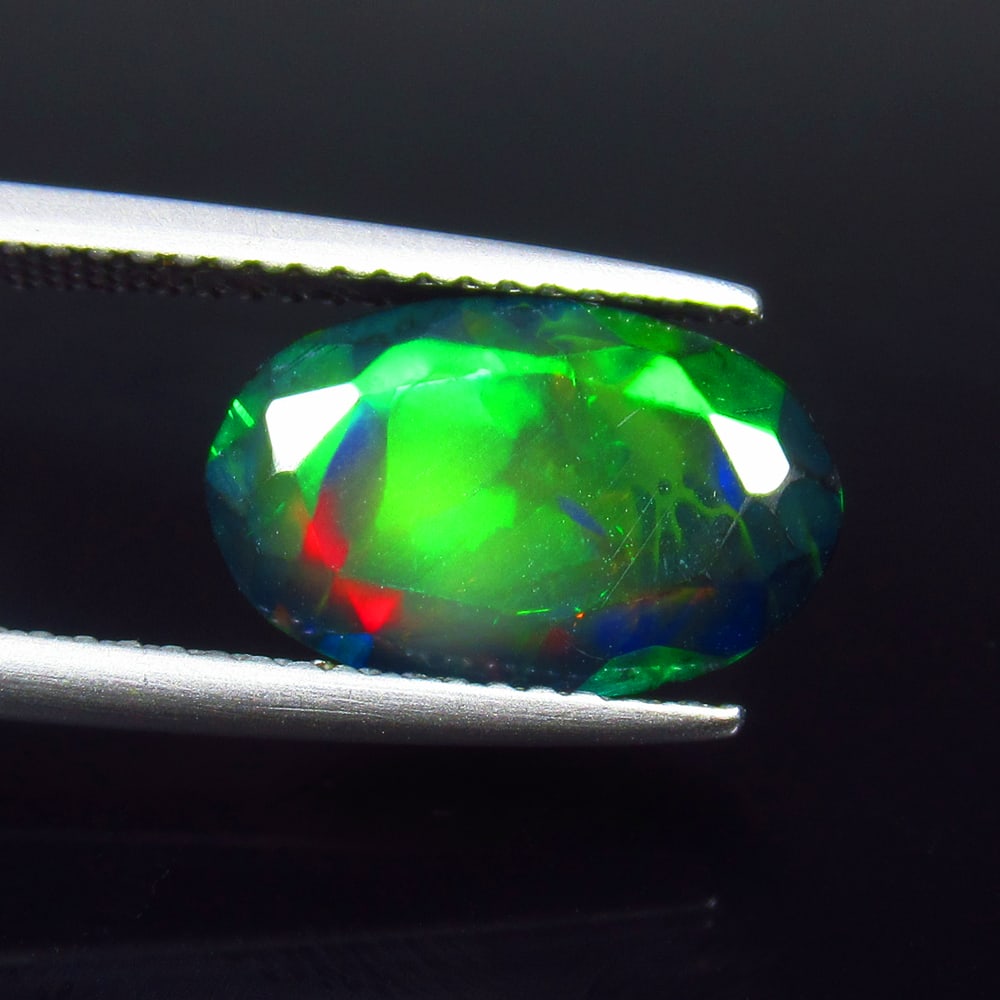 2.42 Ct Natural Black Flashing Fire Opal Oval Cut: Weight - 2.42 Ct / Size - 13.00 x 8.30 x 5.00 mm / Shape - Oval Cut / Color - Black / Clarity - Translucent / Origin - Ethiopia / Treatment - Color Smoked