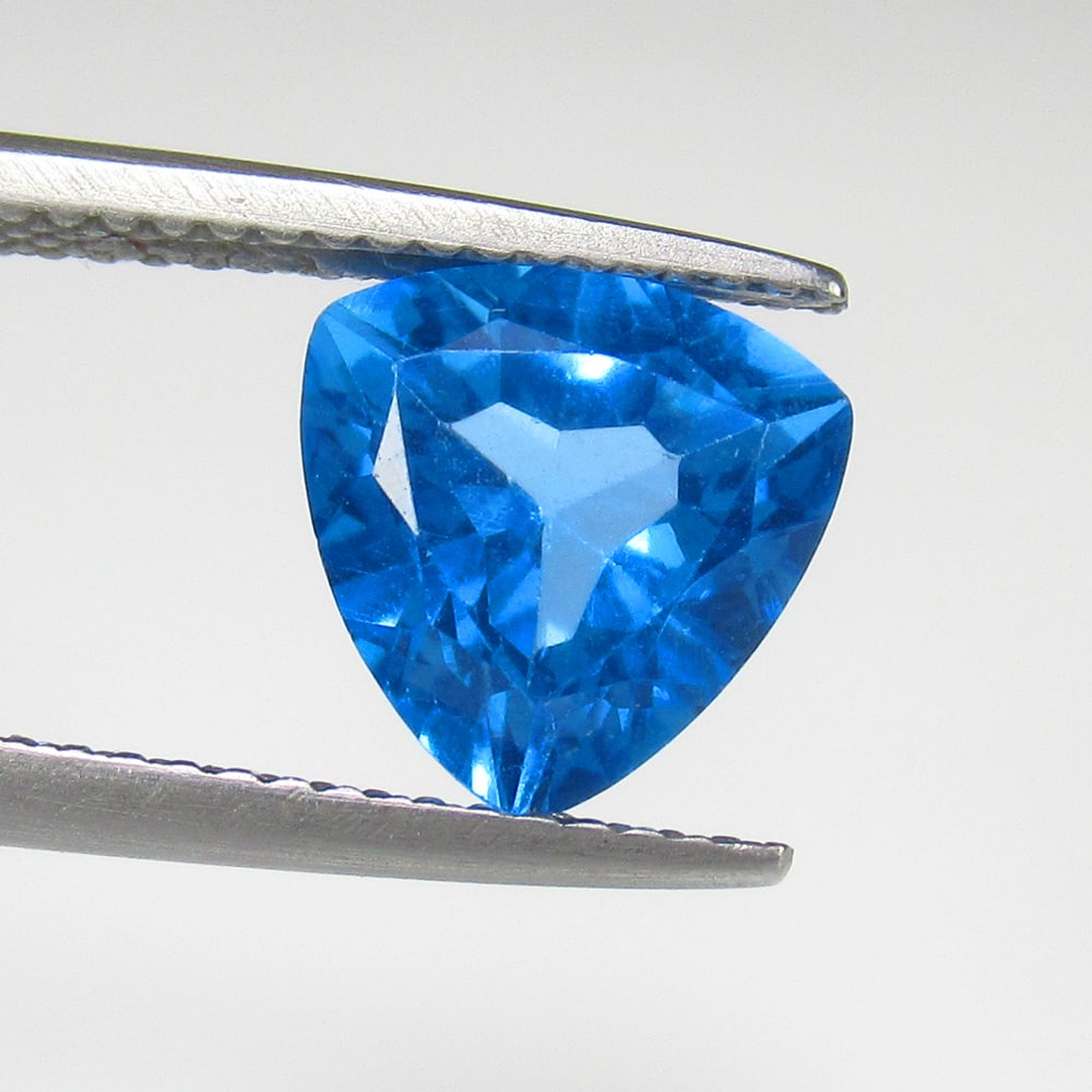 3.00 Ct Natural Blue Topaz Trillion Cut: Weight - 3.00 Ct / Size - 9.20 x 9.20 x 6.00 mm / Shape - Trillion Cut / Color - Blue / Clarity - VVS / Origin - Brazil / Treatment - Irradiated