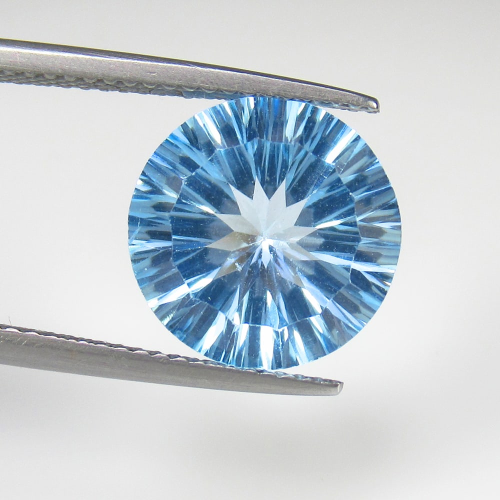 6.49 Ct Natural Blue Topaz Round Concave Cut: Weight - 6.49 Ct / Size - 12.50 x 12.50 x 7.40 mm / Shape - Round Concave Cut / Color - Blue / Clarity - VVS / Origin - Brazil / Treatment - Irradiated