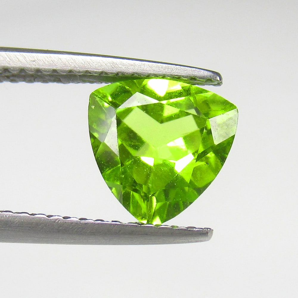 1.63 Ct Natural Green Peridot Trillion Cut: Weight - 1.63 Ct / Size - 7.90 x 7.90 x 4.00 mm / Shape - Trillion Cut / Color - Green / Clarity - VVS / Origin - Pakistan / Treatment - None