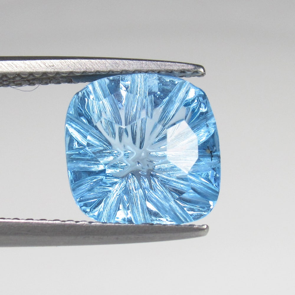 5.73 Ct Natural Blue Topaz Cushion Carving: Weight - 5.73 Ct / Size - 10.40 x 10.40 x 7.30 mm / Shape - Cushion Carving / Color - Blue / Clarity - VVS / Origin - Brazil / Treatment - Irradiated