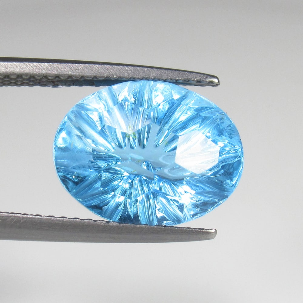 7.81 Ct Natural Blue Topaz Oval Carving: Weight - 7.81 Ct / Size - 13.60 x 10.70 x 8.30 mm / Shape - OVal Carving / Color - Blue / Clarity - VVS / Origin - Brazil / Treatment - Irradiated