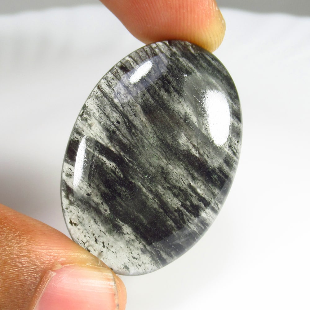 48.08 Ct Natural Black Rutile Quartz Oval Cab: Weight - 48.08 Ct / Dimensions - 36.00 x 25.00 x 16.00 mm / Shape & Cut - Oval Cab / Transparency - Semi Transparent / Origin - Norway / Comments - None