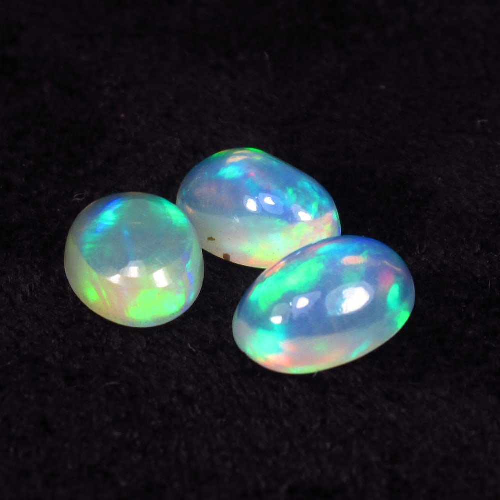 1.58 Ct Natural Multicolor Welo Opal Fire Oval Cab Set: Weight - 1.58 Ct / Dimensions - 6.9x5.0 - 7.2x5.2 mm / 3 Pc's / Shape & Cut - Oval Cab / Color - Multicolor / Transparency - Translucent / Origin - Ethiopia / Comments - None