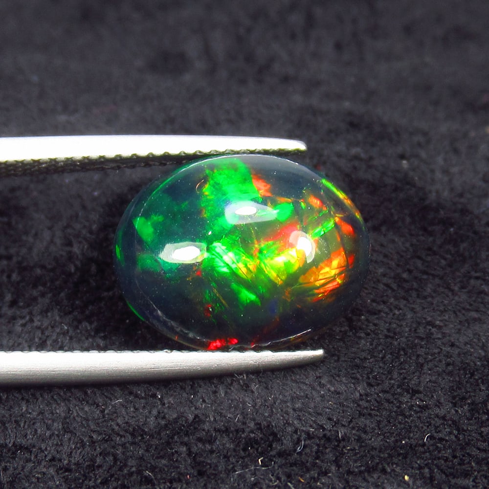 3.49 Ct Natural Black Flashing Fire Opal Oval Cab: Weight - 3.49 Ct / Size - 14.00 x 10.90 x 5.40 mm / Shape - Oval Cab / Color - Black / Clarity - Translucent / Origin - Ethiopia / Treatment - Color Smoked