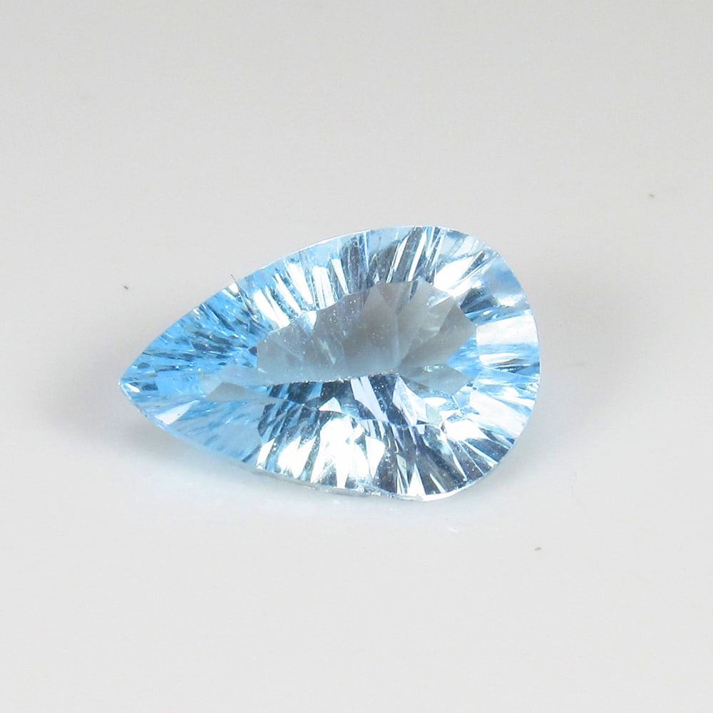 2.60 Ct Natural Blue Topaz Pear Concave Cut: Weight - 2.60 Ct / Size - 12.00 x 8.00 x 4.70 mm/ Shape - Pear Cut / Color - Blue / Clarity - VVS / Origin - Brazil / Treatment - Irradiated