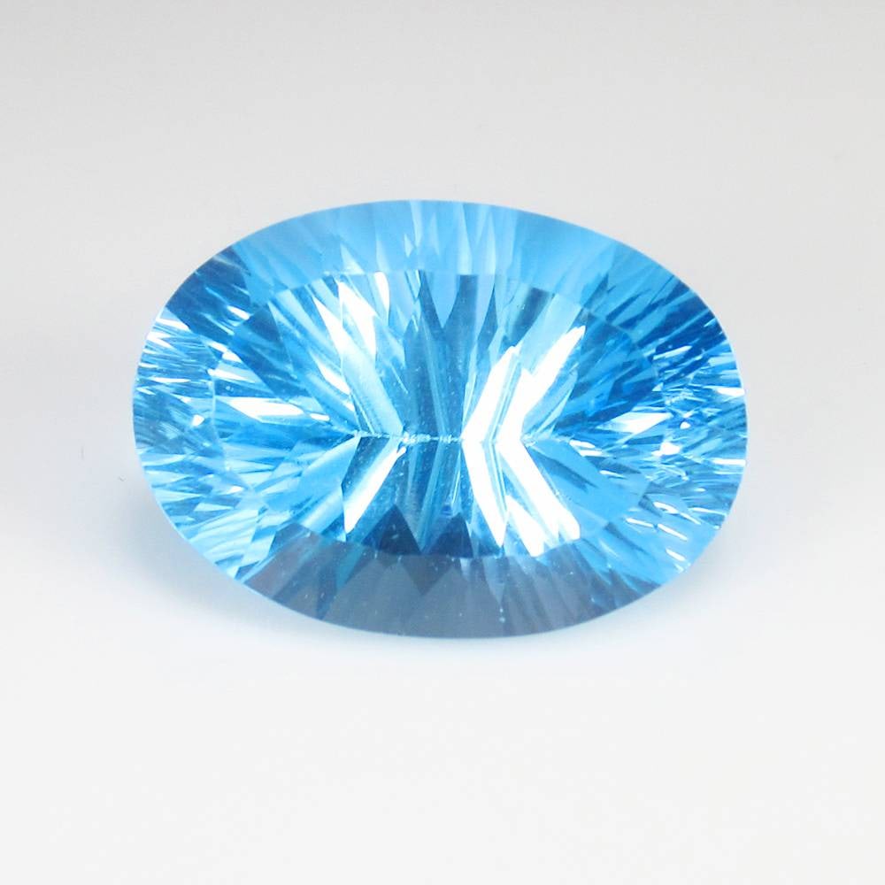 21.41 Ct Natural Flawless Swiss Blue Topaz Oval Cut: Weight - 21.41 Ct / Dimensions - 20.00 x 14.30 x 10.70 mm / Shape & Cut - Oval Concave Cut / Color - Blue / Transparency - VVS / Origin - Brazil / Comments - Irradiated