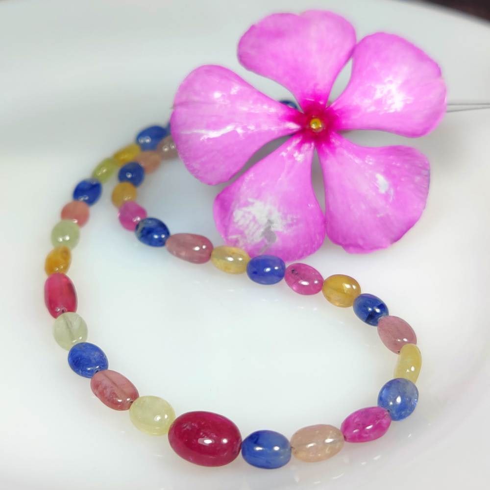 64.73 Ct Natural Multicolor Sapphire 12" Oval Drilled Loose Beads: Weight - 64.73 Ct / Dimensions - 6.10 x 5.20 - 9.70 x 7.20 mm / 42 Pc's / 12" inches / Shape & Cut - Oval Cab Beads / Color - Multicolor / Transparency - Transparent / Comments - Standard Heated