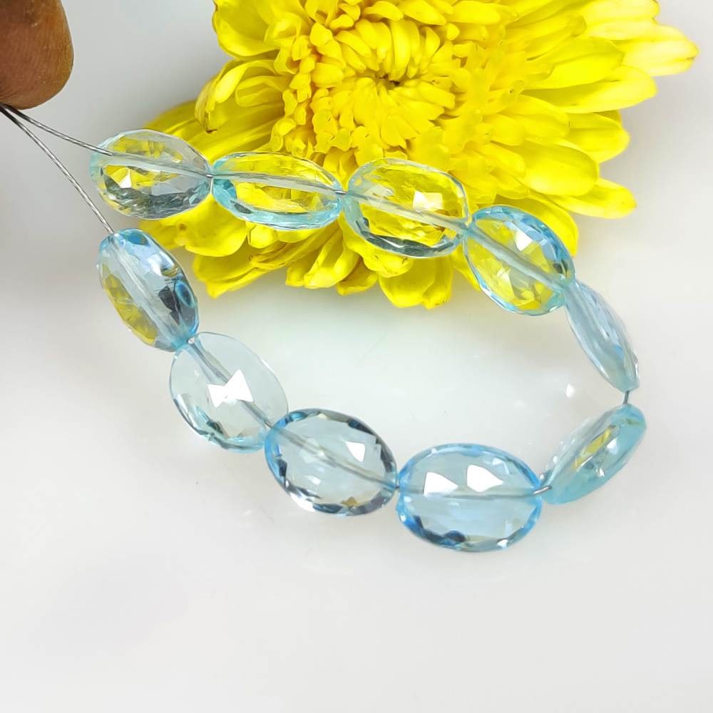 24.56 Ct Natural Blue Topaz 3" Oval Faceted Drilled Beads: Weight - 24.56 Ct / Dimensions - 8.80 x 6.90 - 9.70 x 7.10 mm / 10 Pc's / Shape - Oval Cut Beads / Color - Blue / Transparency - Transparent / Origin - Brazil / Treatment - Irradiated