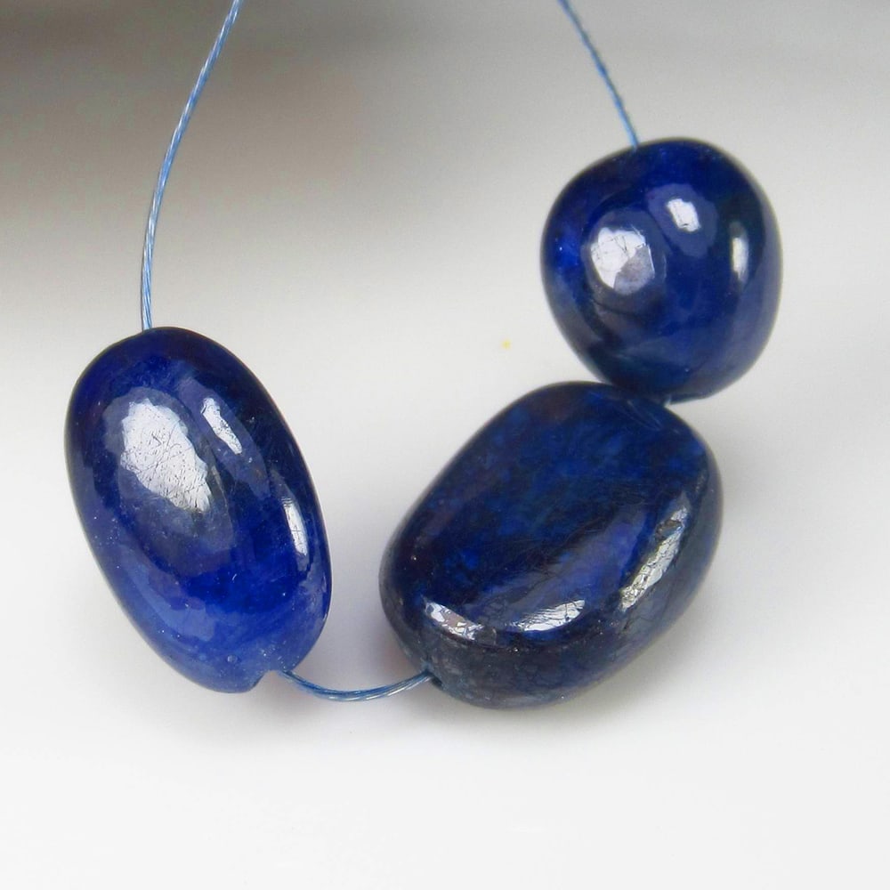 19.16 Ct Natural Blue Sapphire Dumble Beads: Weight - 19.16 Ct / Dimensions- 9.2x8.3 - 12.4x9.3 mm / 3 Pc's / Shape - Dumble Beads / Clarity - SI / Origin - Sri Lanka / Treatment - Standard Heated