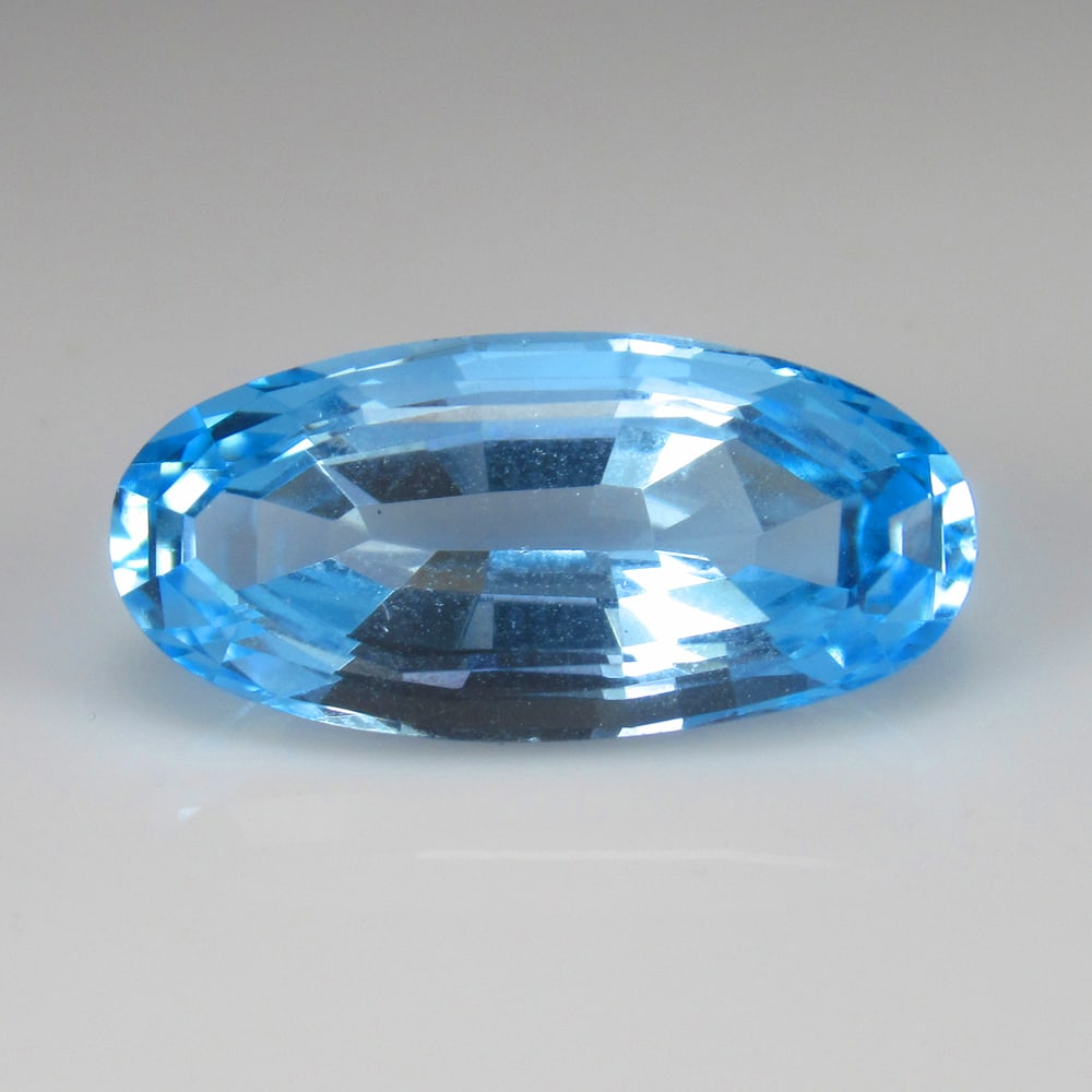 8.00 Ct Natural Blue Topaz OVal Cut: Weight - 8.00 Ct / Size - 17.70 x 8.50 x 6.60 mm / Shape - Oval Cut / Color - Blue / Clarity - VVS / Origin - Brazil / Treatment - Irradiated