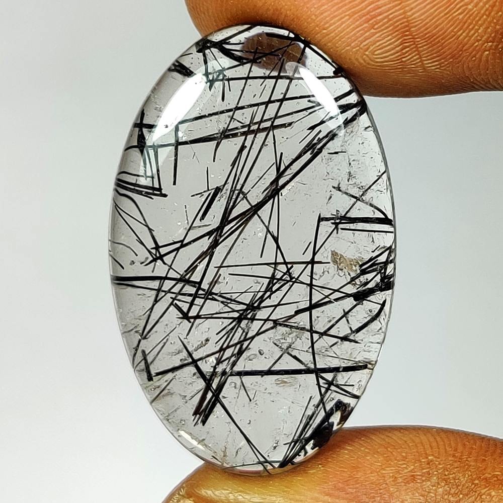 33.44 Ct Natural Black Lined Rutile Quartz Oval Cab: Weight - 33.44 Ct / Dimensions - 33.00 x 20.10 x 6.00 mm / Shape - Oval Cab / Clarity - Transparent / Origin - Norway / Treatment - None