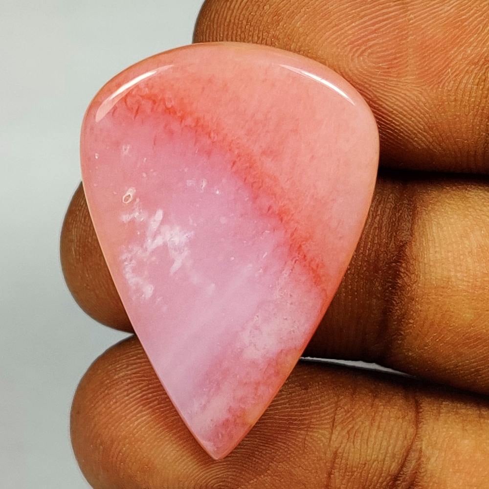 23.07 Ct Natural Peru Pink Opal Pear Cab: Weight - 23.07 Ct / Dimensions - 34.00 x 24.00 x 5.10 mm / Shape - Pear Cabochon / Transparency - Opaque / Origin - Peru/ Treatment - None
