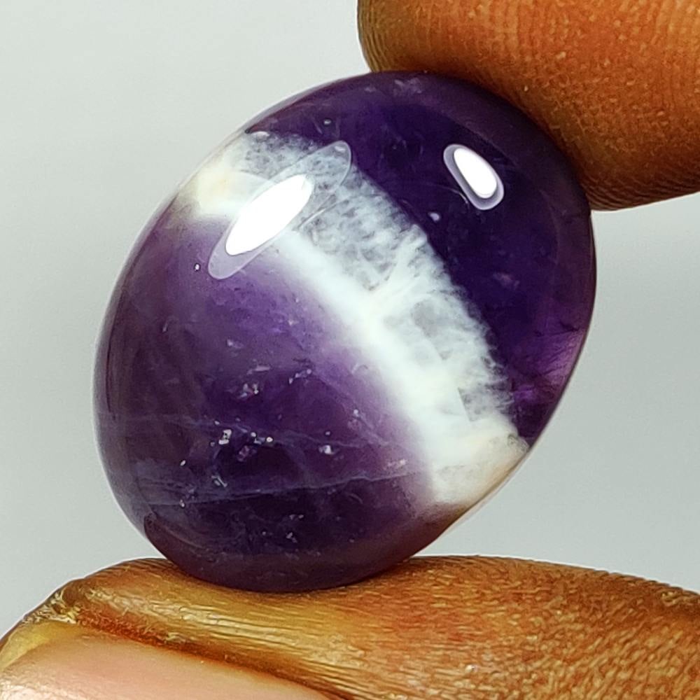 18.09 Ct Natural Chevron Purple Amethyst Oval Cab: Weight - 18.09 Ct / Dimensions - 20.40 x 15.90 x 6.90 mm / Shape - Oval Cab / Color - Purple / Transparency - Semi-Transparent/ Origin -Brazil / Treatment - None
