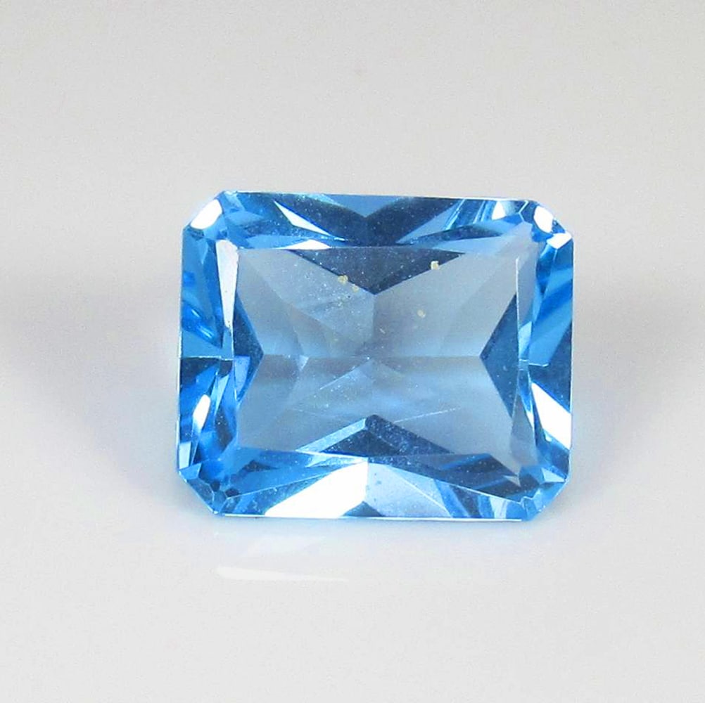 5.13 Ct Natural Blue Topaz Octagon Cut: Weight - 5.13 Ct / Size - 11.00 x 9.00 x 5.70 mm / Shape - Octagon Cut / Color - Blue / Clarity - VVS / Origin - Brazil / Treatment - Irradiated