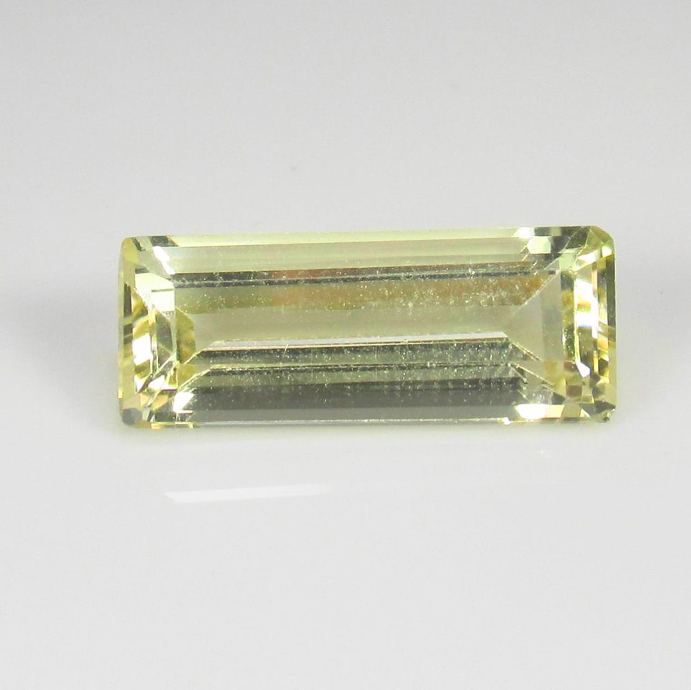 3.80 Ct Natural Yellow Beryl Bougette Cut: Weight : 3.80 Ct / Dimensions : 15.70 x 6.50 x 4.90 mm / Shape : Bougette Cut / Color : Orangish Yellow / Transparency : Transparent / Treatment : Heated