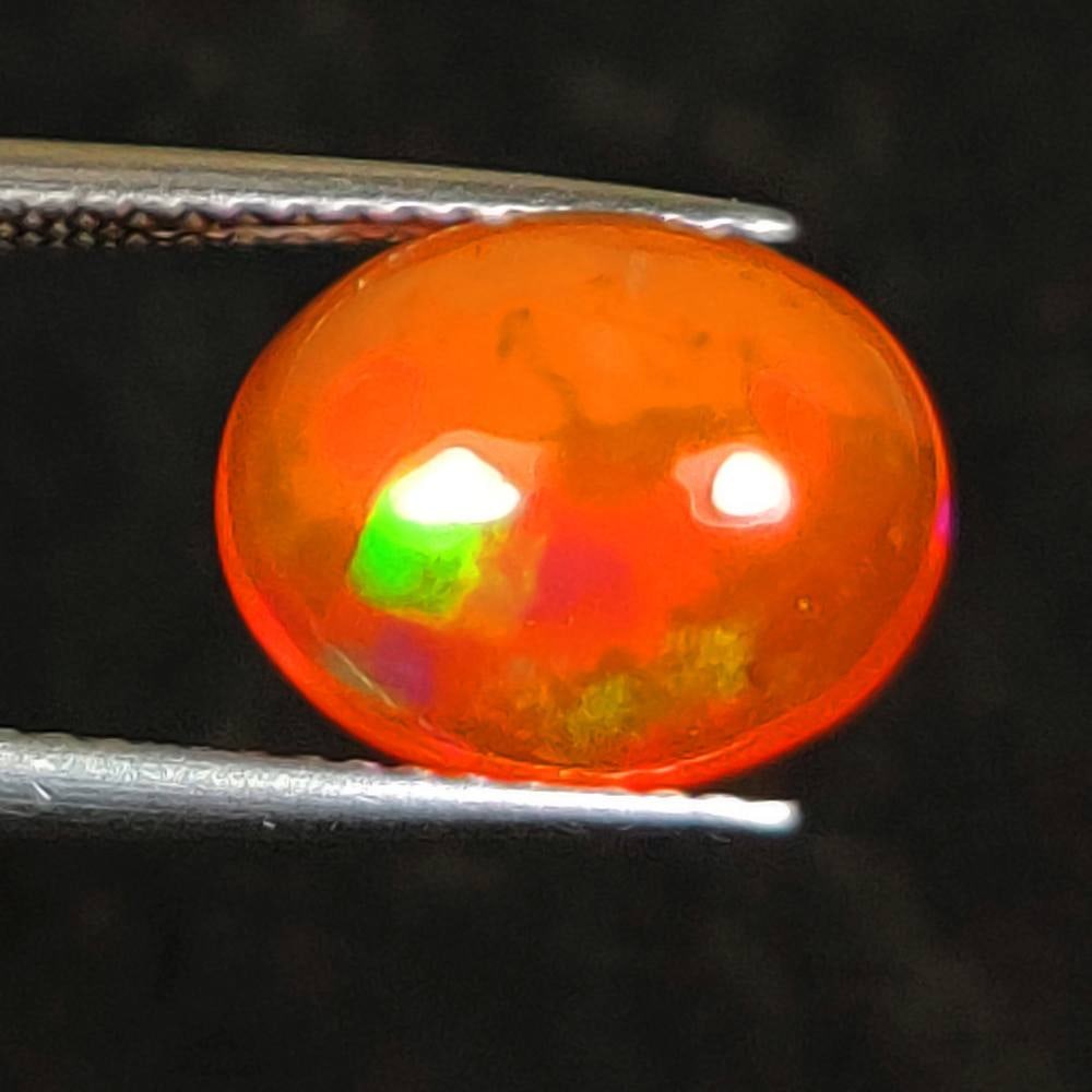 2.61 Ct Natural Orange Flashing Fire Opal Oval Cab: Weight - 2.61 Ct / Dimensions - 11.50 x 9.10 x 5.20 mm / Shape - Oval Cab / Color - Orange / Clarity - Translucent / Origin - Ethiopia / Treatment - Heated