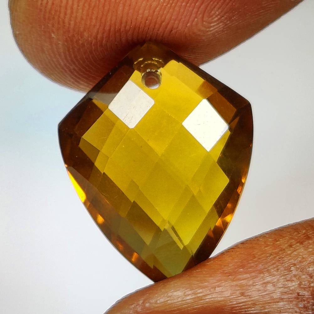 11.61 Ct Natural Yellow Citrine Drilled Fancy Checkerboard Cut: Weight - 11.61 Ct / Dimensions - 18.90 x 14.30 x 8.40 mm / Shape & Cut - Drilled Fancy Checkerboard Cut / Color - Yellow / Clarity - VVS / Origin - Brazil / Comments - Heated