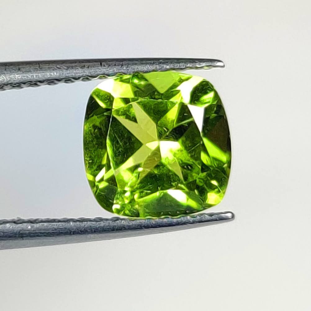 1.73 Ct Natural Green Peridot Cushion Cut: Weight - 1.73 Ct / Dimensions - 7.40 x 7.30 x 4.60 mm / Shape - Cushion Cut / Color - Green / Clarity - VVS / Origin - Pakistan / Treatment - None