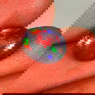 1.72 Ct Natural Black Flashing Fire Opal Oval Cab: Weight - 1.72 Ct / Dimensions - 10.00 x 8.00 x 4.00 mm / Shape - Oval Cab / Color - Black / Clarity - Translucent / Origin - Ethiopia / Treatment - Color Smoked