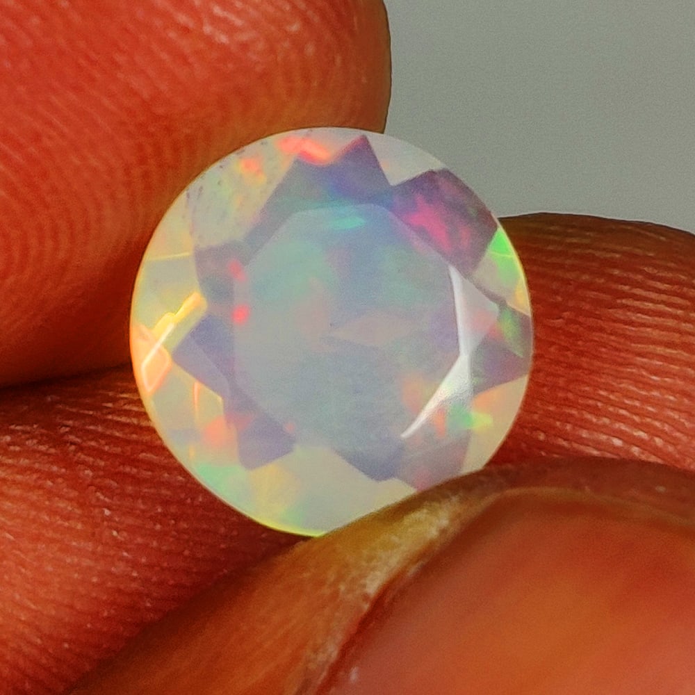 1.69 Ct Natural Multi-Color Welo Opal Flash Fire Round Cut: Weight - 1.69 Ct / Size - 9.40 x 9.40 x 4.50 mm / Shape - Round Cut / Color - Multicolor / Clarity - Translucent / Origin - Ethiopia / Treatment - None