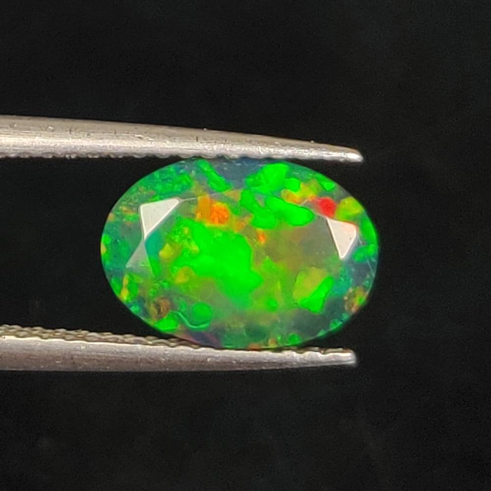 1.12 Ct Natural Black Flashing Fire Opal Oval Cut: Weight - 1.12 Ct / Dimensions - 10.10 x 7.10 x 3.20 mm / Shape - Oval Cut / Color - Black / Clarity - Translucent / Origin - Ethiopia / Treatment - Color Smoked