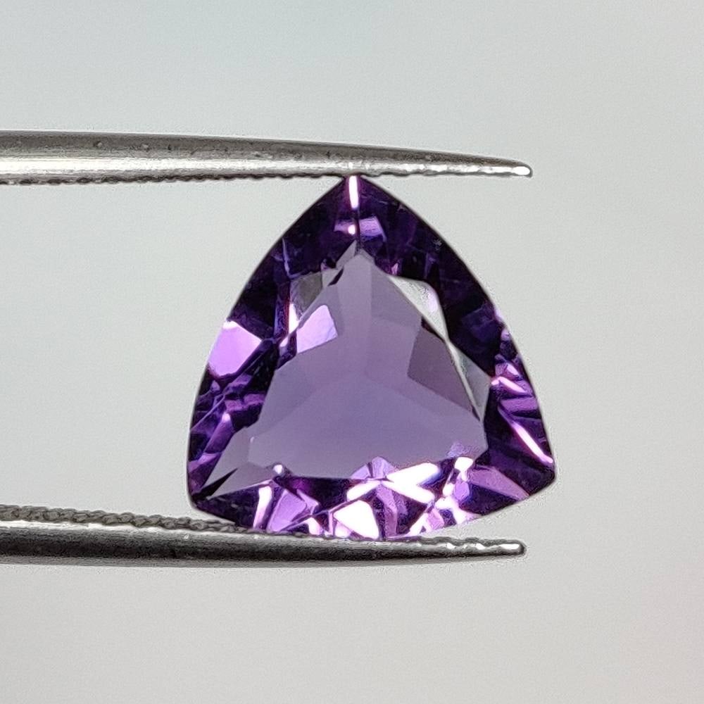 2.94 Ct Natural Purple Amethyst Trillion Cut: Weight - 2.94 Ct / Dimensions - 10.80 x 10.70 x 5.20 mm / Shape - Trillion Cut / Color - Purple / Clarity - VVS / Origin - Brazil / Treatment - Heated
