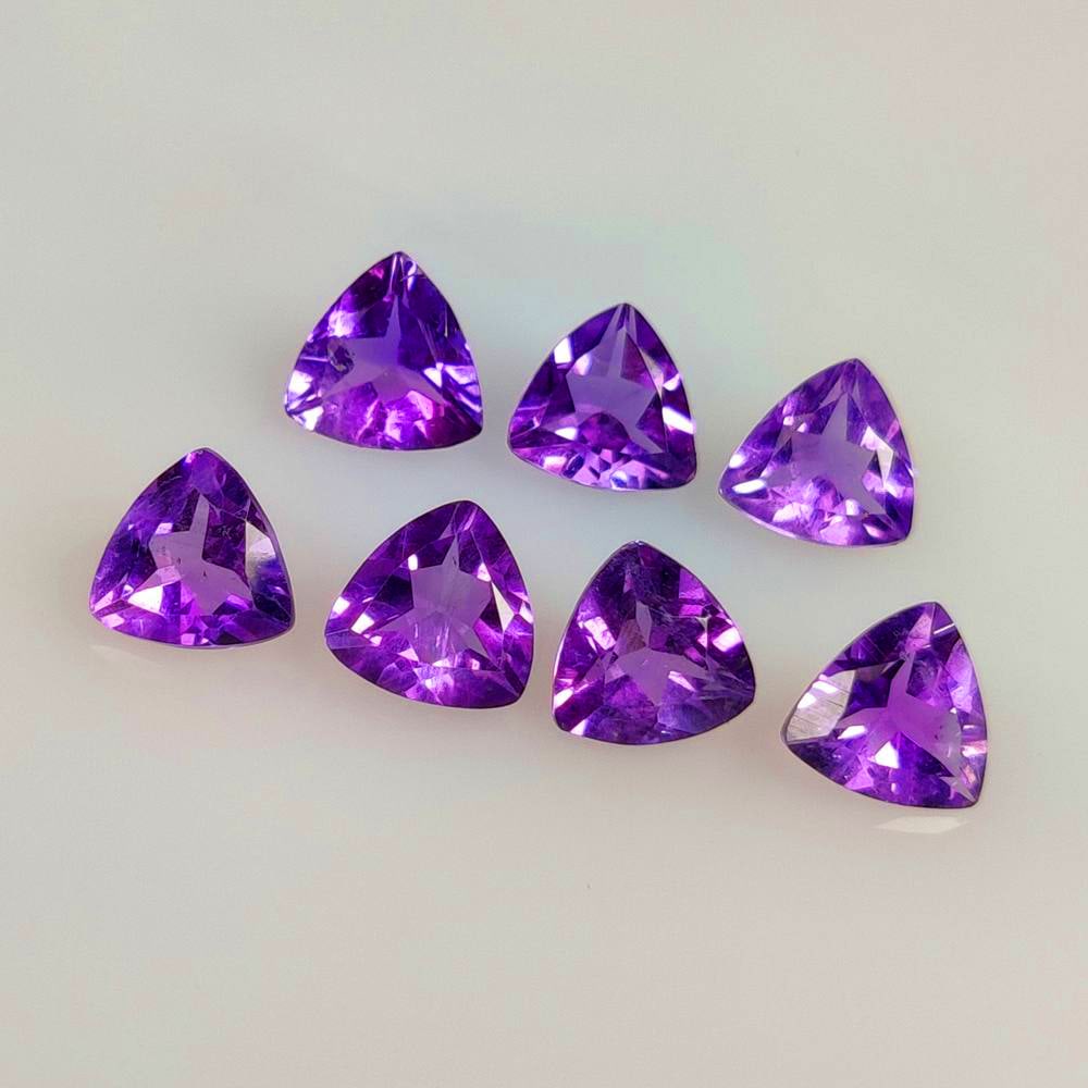 4.29 Ct Natural Purple Amethyst Trillion Cut Set: Weight - 4.29 Ct / Size - 6.0x3.3 - 6.1x3.7 mm / 7 Pc's / Shape - Trillion Cut / Color - Purple / Clarity - VVS / Origin -Brazil / Treatment - Heated