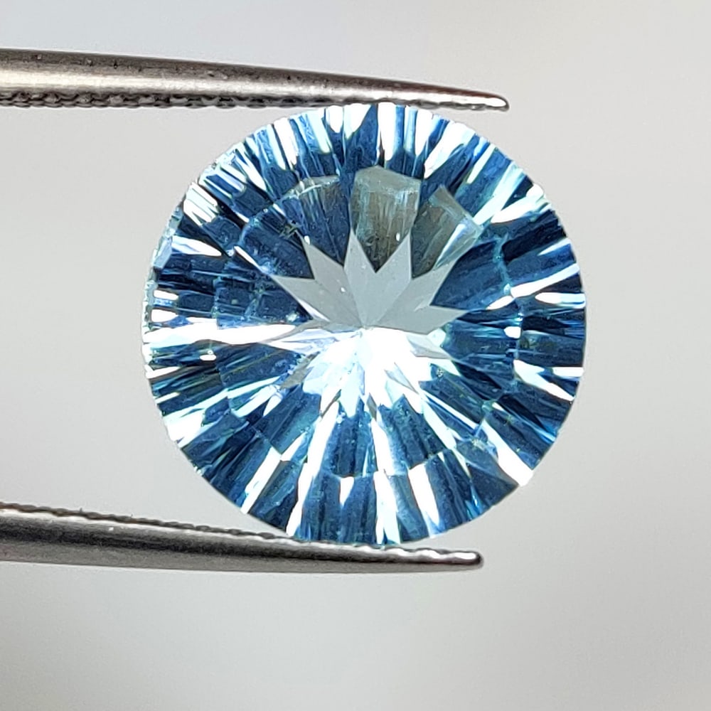 6.16 Ct Natural Blue Topaz Round Concave Cut: Weight - 6.16 Ct / Size - 12.00 x 12.00 x 6.60 mm / Shape - Round Concave Cut / Color - Blue / Clarity - VVS / Origin - Brazil / Treatment - Irradiated